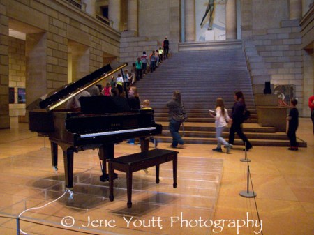 school children on grand staircase with cage piano